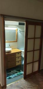 a bathroom with a sink and a mirror at Ohana RBNB studio "Havai " in Uturoa