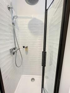 a bathroom with a shower with a glass door at Le Agathe - Urbain et Bohème in Compiègne