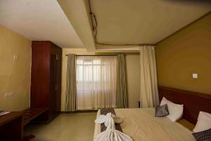 a bedroom with a bed with a dress on it at Acacia Resort Wote-Makueni by Nest & Nomad in Wote