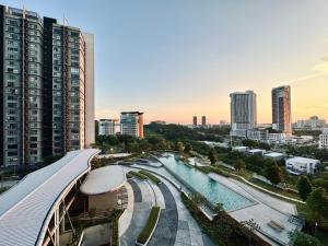 a view of a city with a pool and buildings at Cozy Hyve Soho Suites in Cyberjaya