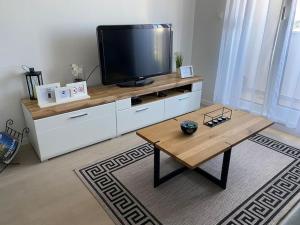 a living room with a tv and a coffee table at New modern APT near Old town - private parking in Zadar