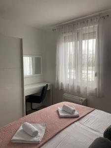 a bedroom with a bed with two towels on it at New modern APT near Old town - private parking in Zadar