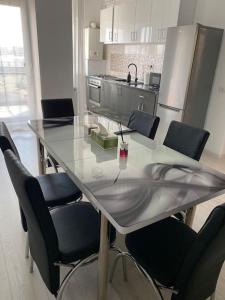 a kitchen with a table with chairs and a counter top at Apartament tip studio in Roşu