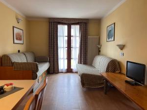 TV a/nebo společenská místnost v ubytování Nevesole Folgarida Resort Aparthotel