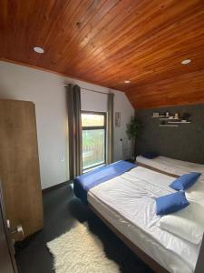 1 dormitorio con 1 cama grande y techo de madera en Forest house, en Gabala