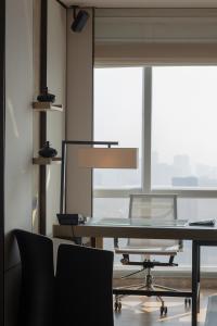an office with a table and chairs and a large window at Shenzhen Marriott Hotel Nanshan in Shenzhen