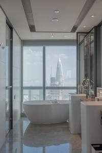 a bathroom with a tub and a view of a building at Shenzhen Marriott Hotel Nanshan in Shenzhen
