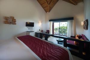 a bedroom with a bed and a desk and a window at Punta Cana Princess Adults Only - All Inclusive in Punta Cana
