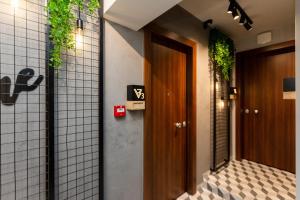 a hallway with a door and plants on the walls at Valaoritou 3 Luxury Rooms in Thessaloniki