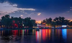 a view of a river at night at Happy Dragon Alley Hotel-In the city center with big window&free coffe, Fluent English speaking,Tourist attractions ticket service&food recommendation,Near Tian Anmen Forbiddencity,Near Lama temple,Easy to walk to NanluoAlley&Shichahai in Beijing