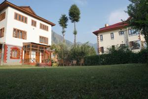 a large house with a lawn in front of it at Aubiz Villa in Srinagar