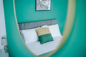 a mirror reflection of a bed with a green pillow at Spacious house near City Centre -Sleeps 8 - Parking in Liverpool