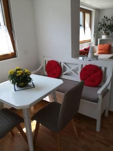 a living room with a table and a table and chairs at Garten-Wohnung in Eschen