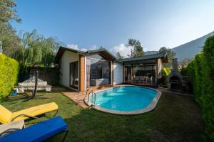 a backyard with a swimming pool and a house at TERRA PİNE in Kayakoy