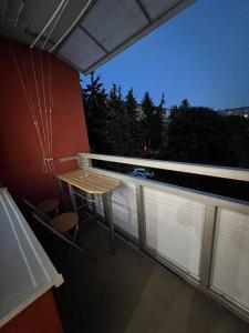 a balcony with a table and a view of the city at Plne vybavený trojizbový apartmán neďaleko centra in Levice