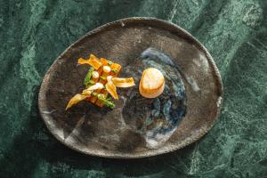 a plate of food on a green table at L'Alpaga, a Beaumier hotel in Megève