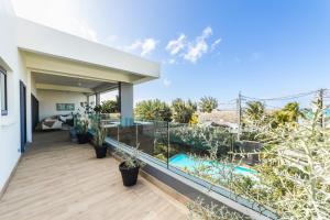 a balcony with a view of a house at Modern Penthouse - Nautilya BS1 in Grand Baie