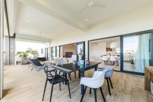 a dining room with a table and chairs at Modern Penthouse - Nautilya BS1 in Grand Baie