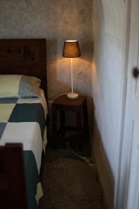 a bedroom with a bed and a lamp on a table at Relais del Brigante in Settimo Vittone