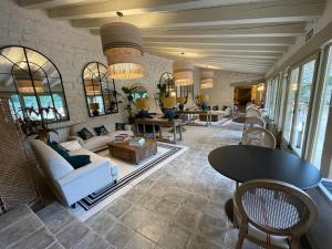 a living room with couches and tables and windows at Maison Barón de la Galleta B&B in Quintanilla las Torres