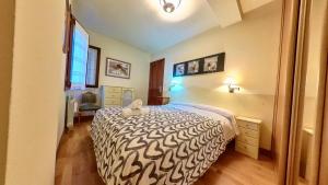 a bedroom with a bed with a stuffed animal on it at El Llano de Escarrilla - tucasaenlospirineos in Escarrilla