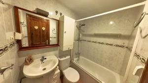 a bathroom with a sink and a toilet and a shower at El Llano de Escarrilla - tucasaenlospirineos in Escarrilla +31 photos