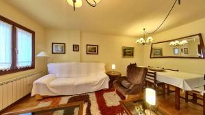 a bedroom with a bed and a table and a chair at El Llano de Escarrilla - tucasaenlospirineos in Escarrilla