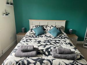 a bed with pillows on it in a bedroom at Claygate Place - Modern 2 Bed House with Parking in Nottingham