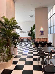 a restaurant with a black and white checkered floor at SurfingStay in Yangyang