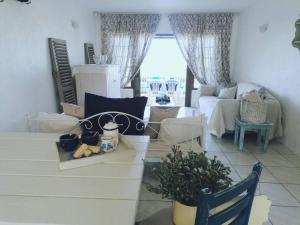 a living room with a couch and a table at Beachfront at 22 Settler's Sands in Port Alfred