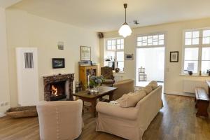 a living room with a couch and a fireplace at Ferienwohnung 1 mit schönem Seeblick in Neuenkirchen