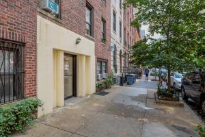 a sidewalk in a city with a building and a street at Murray Hill 2br w wd nr groceries hospital NYC-1228 in New York
