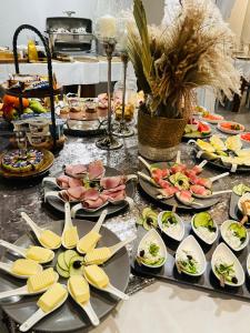 a buffet with plates of food on a table at Piano in Nowy Sącz