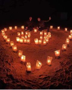 a group of people sitting in a circle of candles at Wadi Rum Bedouin Heart in Wadi Rum +80 photos