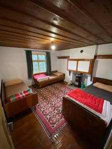 a large room with two beds and a rug at Spring House Изворна Къща 
