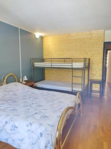 a bedroom with two bunk beds in a room at Gîte les deux sources au pied du Vercors in Saint-Laurent-en-Royans