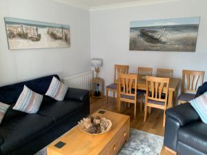 a living room with a couch and a table at 8Murrayfield, St Abbs in Saint Abbs