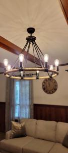 a chandelier in a living room with a couch at Whole House 85 Acre Private Ranch Sleeps 8, hot-tub king beds in Logan