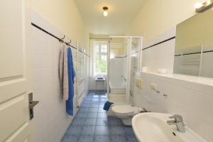 a white bathroom with a sink and a toilet at Ferienwohnung 3 mit gr Terrasse und Wasserblick in Neuenkirchen