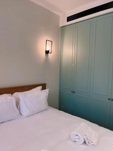 a bedroom with a bed with two towels on it at Rosa’s place in Jerusalem