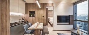 a kitchen and living room with a table and chairs at The Stellar in Hong Kong