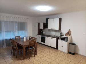 a kitchen with a table and a kitchen with white cabinets at Gaststätte Neumann in Saarlouis