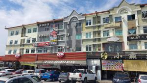 a large building with cars parked in front of it at OYO 90789 Stutong Point in Kuching