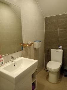 a bathroom with a sink and a toilet and a mirror at C113 Home-1bedroom in Phnom Penh
