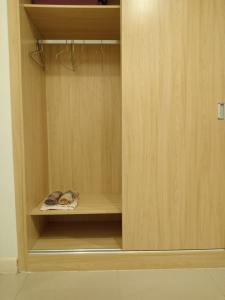 a closet with a wooden cabinet with a shelf at C113 Home-1bedroom in Phnom Penh