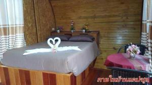 a bedroom with a bed with white towels on it at The Memorize Resort in Ban Non Na Yao