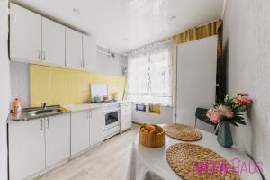 a kitchen with a table with a bowl of fruit on it at Квартира в центре Золотой in Petropavlovsk