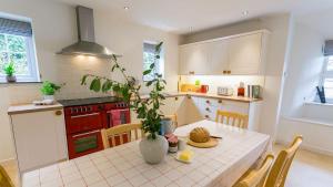 a kitchen with a table with a vase on it at Aber in Moelfre