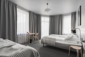 Postel nebo postele na pokoji v ubytování Heimen Hotel