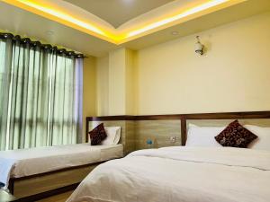 Postelja oz. postelje v sobi nastanitve Hotel Balgopal